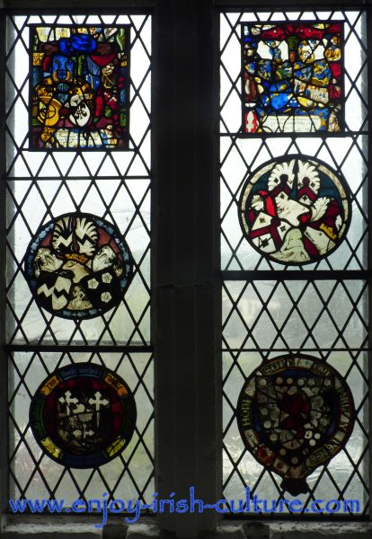 A stain glass window at Bunratty Castle, County Clare, Ireland shows heraldic symbols of medieval owners of this Irish castle.